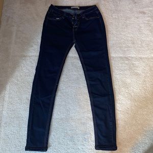 Encore dark wash skinny stretch jeans with brown stitch border.